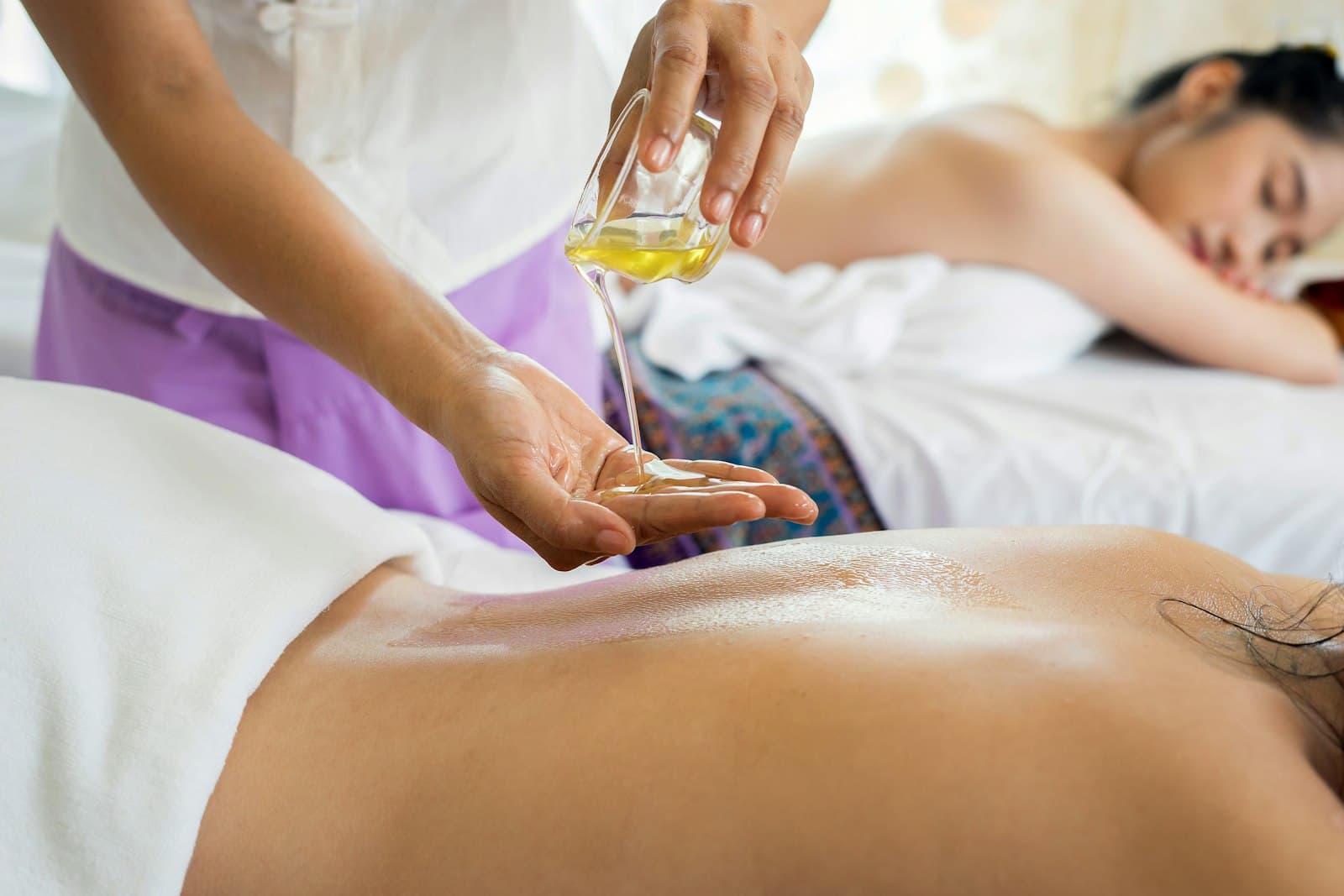 Huile d'argan versée au creux de la main avant un massage au Spa Azur